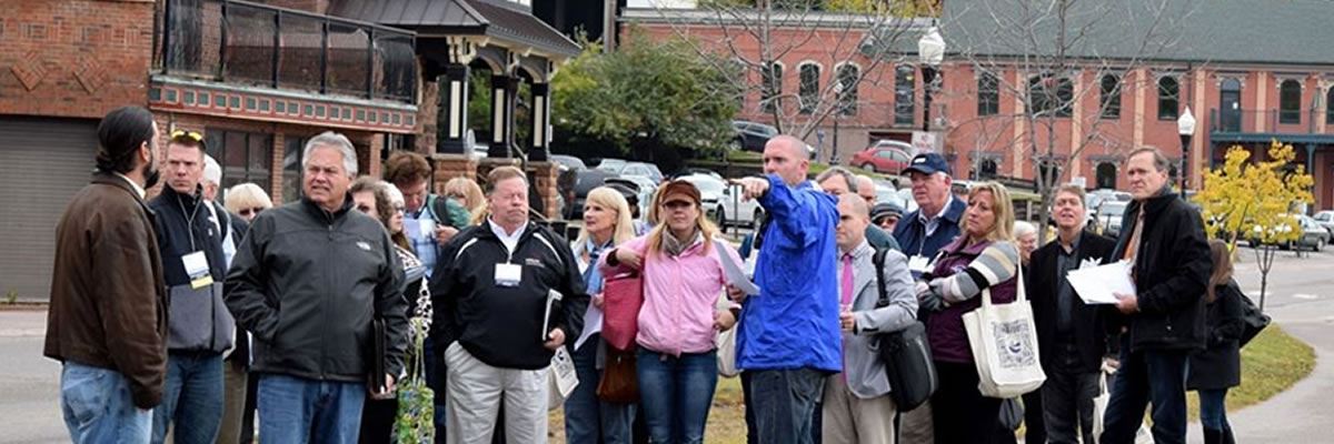 A group of people take a tour of a downtown area